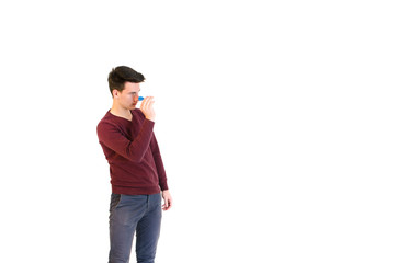 Teenager man wearing a sweater throwing when play darts isolated on white