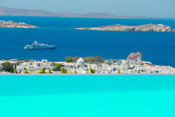 Top view of the old city and the sea on the island of Mykonos, Greece. A lot of white houses against the blue sky