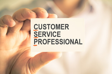 Businessman holding card with CSP CUSTOMER SERVICE PROFESSIONAL acronym text