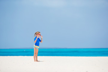 Fototapeta premium Little girl during beach vacation having fun on the white beach