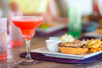 Close up of delicious fresh burger with tasty cocktail
