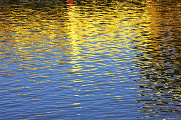 The water surface reflects light blue and yellow