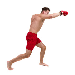 Full length portrait of young male boxer showing some movements against isolated white background
