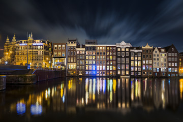 Traditional Dutch old houses on the canals in Amsterdam at night, The Netherlands