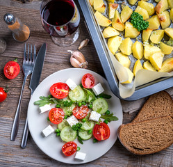 greek salad with cheese, baked potatoes, topview