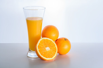Glass of fresh orange juice and orange fruit