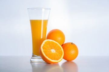 Glass of fresh orange juice and orange fruit