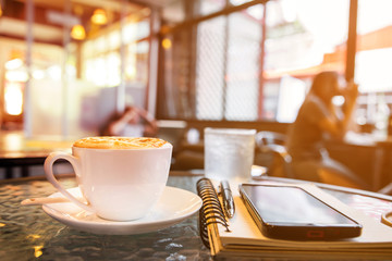 Cup of cappuccino in coffee ship 