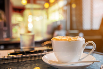 Cup of cappuccino in coffee ship  - obrazy, fototapety, plakaty