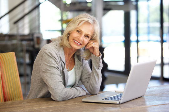 Portrait Of Beautiful Older Woman Working Laptop Computer Indoors