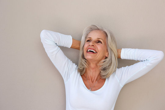 Beautiful Older Woman Leaning With Hands Behind Head