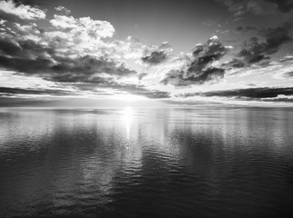 Black and white sunset over water aerial landscape