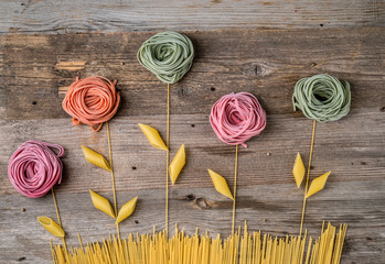Fototapety  flowers composition made of colorful pasta, topview