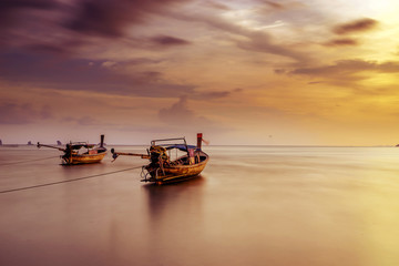 Traditional thai boats at sunset beach. Ao Nang Krabi province