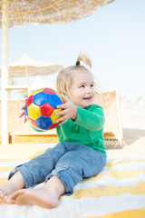 small baby boy with happy face sunny summer with ball