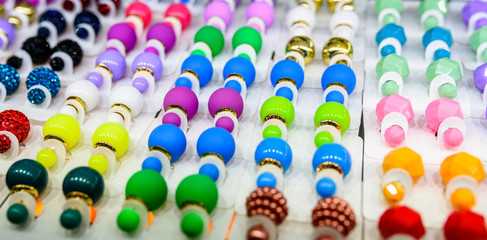 Fototapeta na wymiar Earrings of different colors and for every taste.