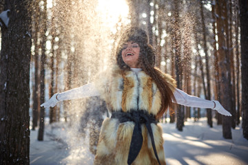 Fototapeta premium beautiful girl in fur vest in winter forest