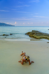 Fototapeta na wymiar Woman on the beach in Surin Phuket