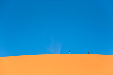 Traveler in the desert, active couple trekking in hot sandy wilderness