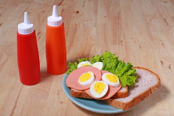 simple breakfast with Sandwich and egg on the wood table