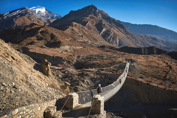 Suspension bridge over the river in Mustang region of Himalayas, Nepal