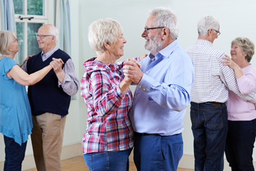 Group Of Seniors Enjoying Dancing Club Together