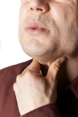 Naklejka premium Close Up Studio Shot Of Man Suffering From Sore Throat