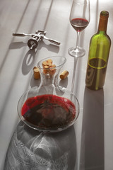 Red wine in decanter, glass and bottle on table
