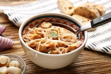 Chicken noodle soup in bowl on wooden table