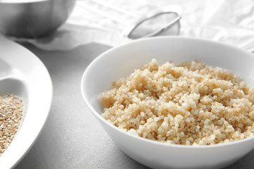 Plate with boiled sprouted organic white quinoa grains, closeup