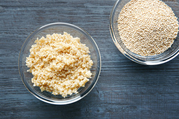 Top view of two glass plates with sprouted organic white quinoa grains on dark background