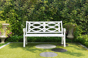 White wood bench chair with bush Background in garden at home.