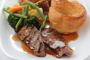 Traditional Sunday roast beef dinner with Yorkshire puddings and gravy