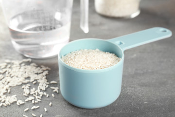Kitchen ware with rice and water on table