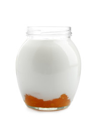 Glass jar with tasty yogurt and jam on white background