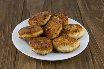 Fresh cutlet in plate isolated on a wooden background. Close up