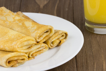 Pancakes or Russian Blintzes on a wooden background. Close up