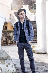 Teenager standing facing the white wall