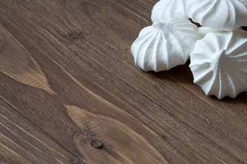 Mini meringues on a wooden background