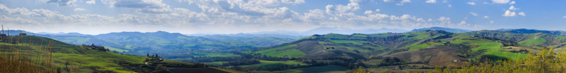 Fototapeta na wymiar Large Panorama of the Apennine hills around the medieval village of Montefabbri. Marche, Italy