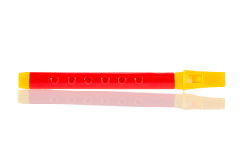 red toy flute isolated on white