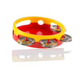 red yellow toy tambourine isolated on white