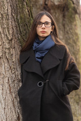 Portrait of a beautiful girl in glasses on the nature