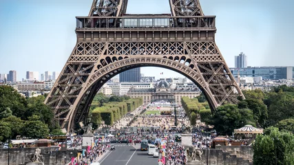 Fotobehang Paris, France - September 10, 2016: The legs of Eiffel Tower with tourist crowd waiting in lines © CanYalicn