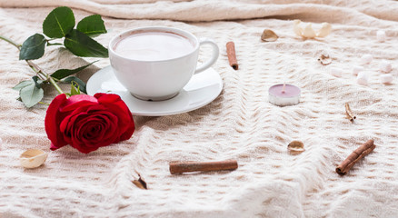 Fototapeta na wymiar Composition with coffee, rose, cinnamon sticks and candles.