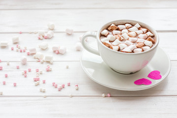 Hot chocolate, marshmallows on wooden white background. Valentine's day.