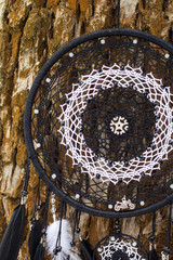 Dreamcatcher made of feathers, leather, beads, and ropes
