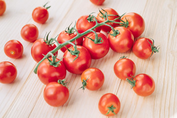 Macro photo of ripe red tomatoes wooden table. Tomatoes on a branch