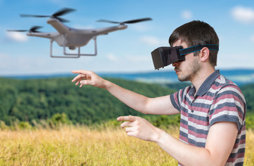 Man wearing virtual reality headset is controlling a flying drone.