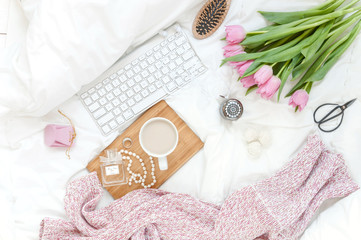 Woman's work place in bed. Top view. Breakfast